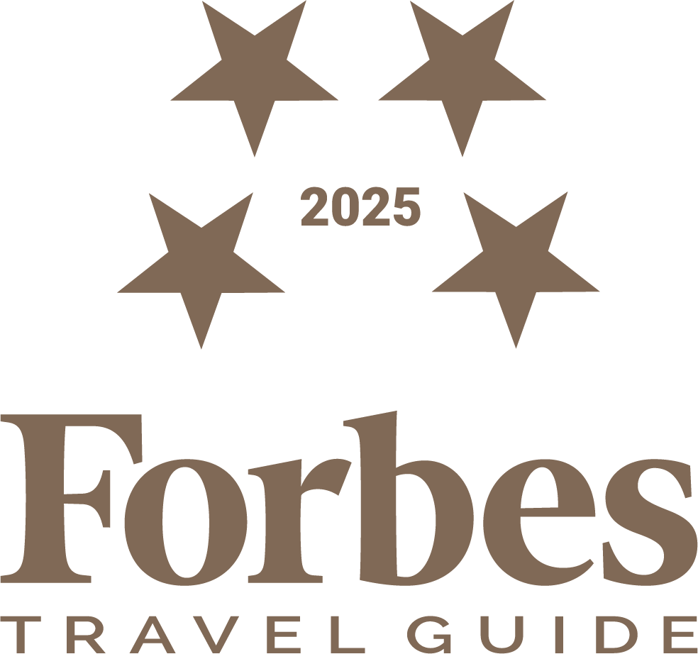 Forbes Travel Guide 2025 logo with four stars.