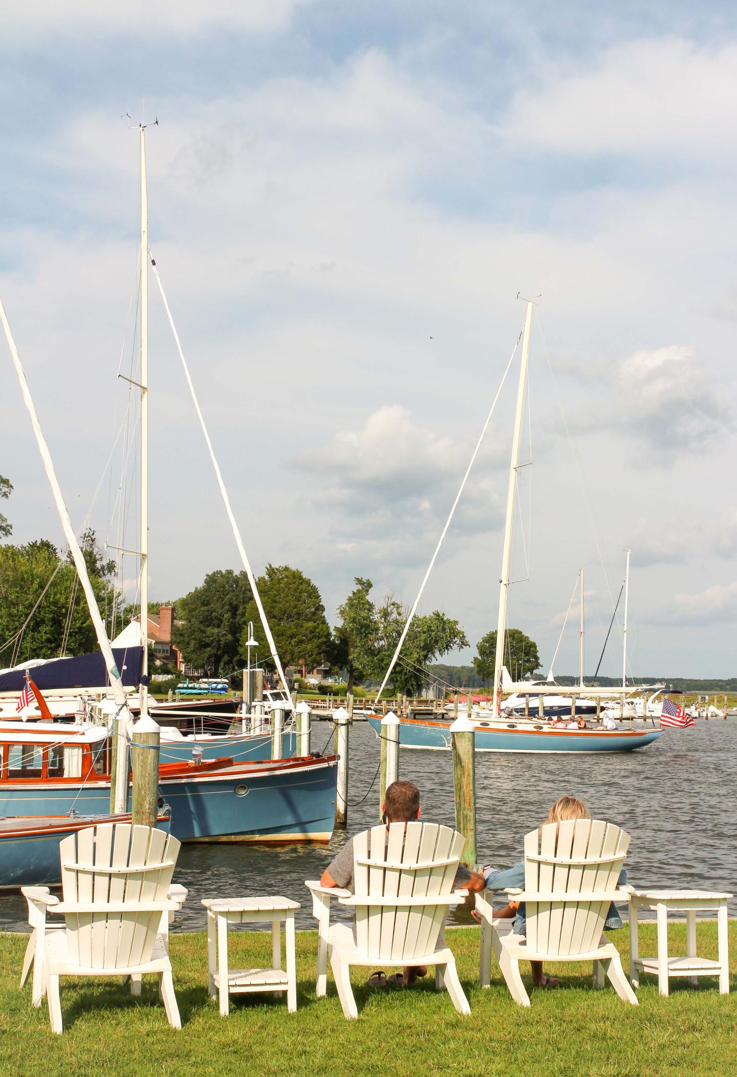 A couple sitting on a harbor