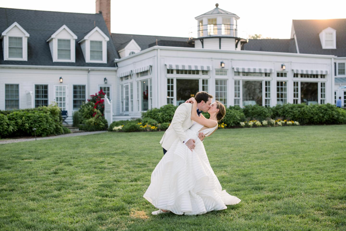 Bride and Groom kissing on the front lawn of Inn at Perry Cabin