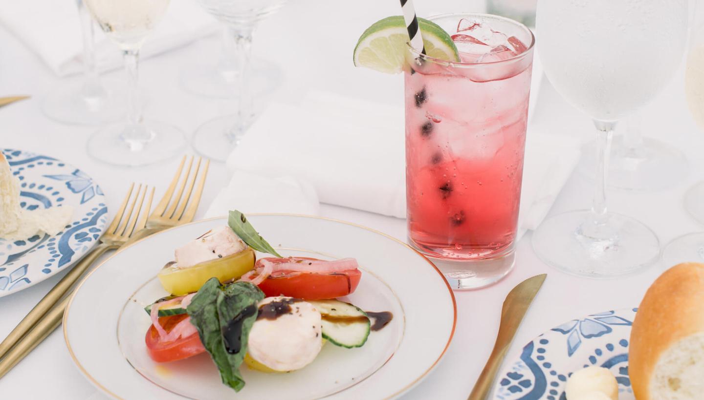 Close up of first course and cocktail during dinner service